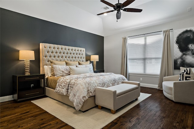 bedroom with baseboards, visible vents, ceiling fan, wood finished floors, and vaulted ceiling