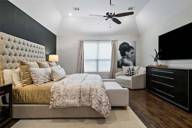 bedroom with dark wood-style floors, ceiling fan, visible vents, and vaulted ceiling