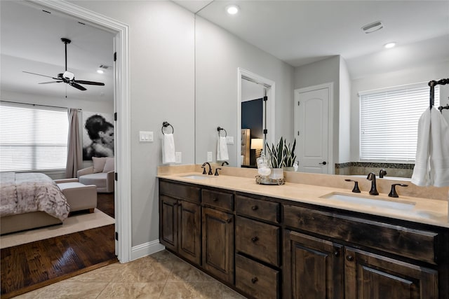 full bath with double vanity, tile patterned flooring, ensuite bath, and a sink