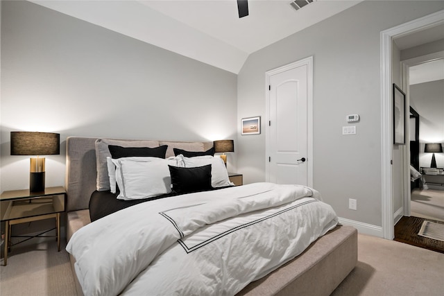 bedroom featuring visible vents, a ceiling fan, carpet flooring, vaulted ceiling, and baseboards