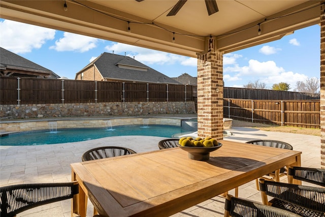 view of swimming pool with a fenced backyard, a fenced in pool, a ceiling fan, and a patio