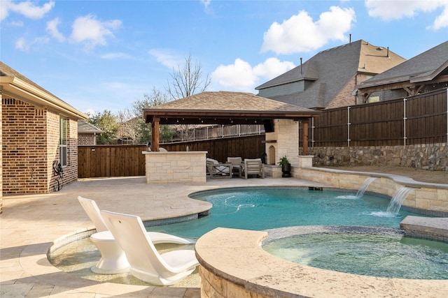 view of swimming pool with a patio area, a fenced backyard, a pool with connected hot tub, and a gazebo