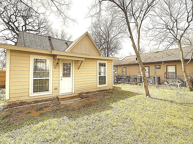 back of house with fence