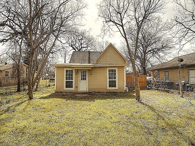 exterior space featuring a lawn and fence