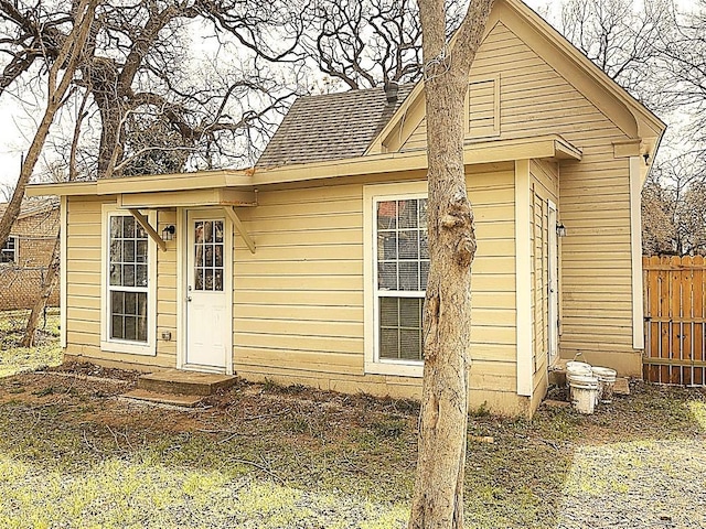 view of outbuilding featuring fence