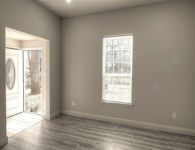 entrance foyer featuring wood finished floors and baseboards