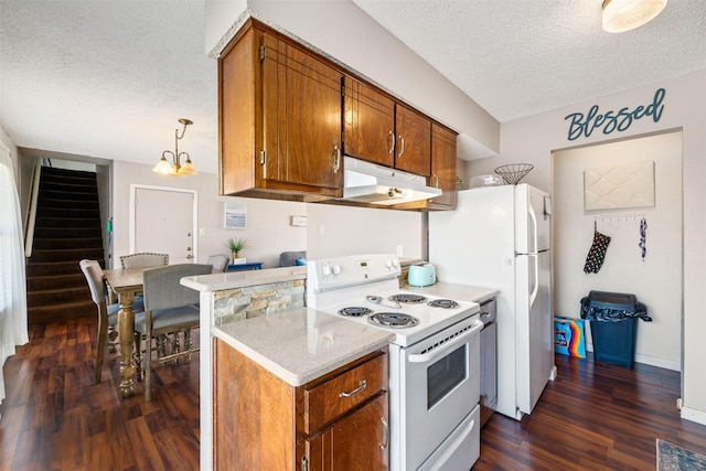 kitchen with brown cabinets, white electric range oven, light countertops, dark wood-type flooring, and under cabinet range hood