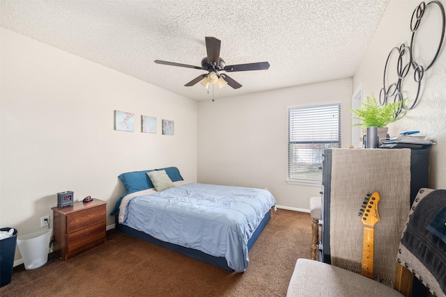 carpeted bedroom featuring baseboards, a ceiling fan, and a textured ceiling