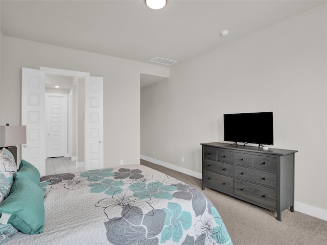 bedroom with carpet floors, visible vents, and baseboards