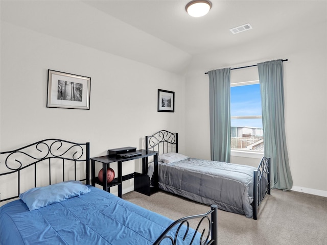 bedroom featuring carpet floors, baseboards, visible vents, and vaulted ceiling