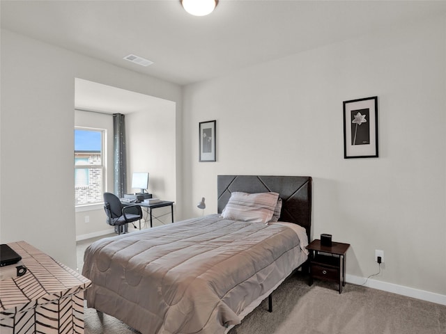 carpeted bedroom with baseboards and visible vents