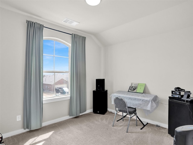 carpeted home office with baseboards, visible vents, and vaulted ceiling