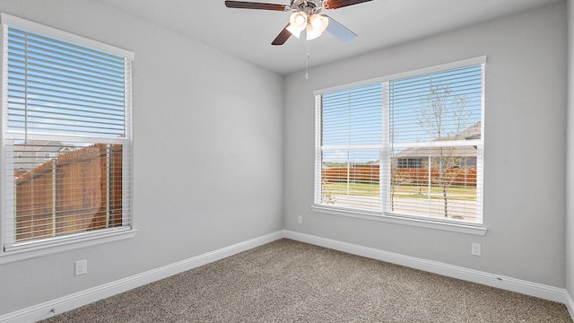 empty room featuring carpet floors, ceiling fan, and baseboards