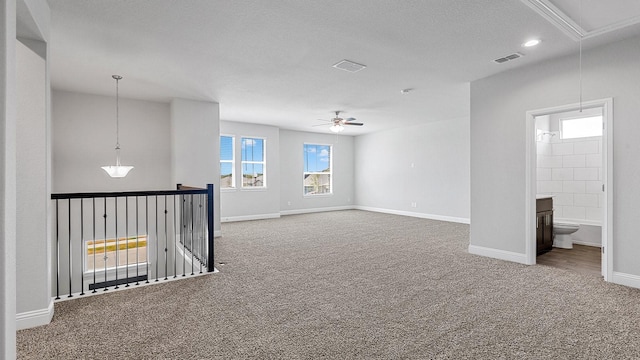 spare room featuring visible vents, carpet, attic access, and baseboards