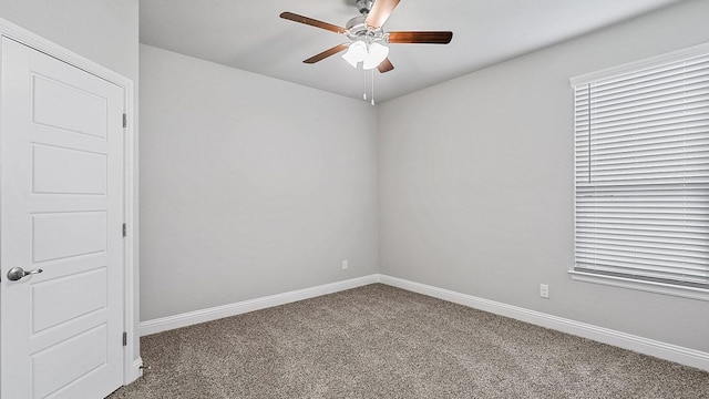 unfurnished room featuring carpet, baseboards, and a ceiling fan