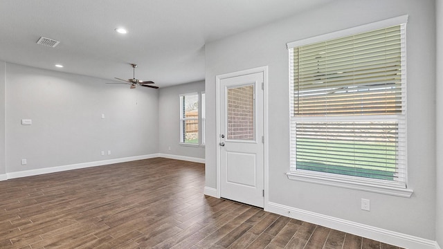 spare room with dark wood-style flooring, recessed lighting, visible vents, ceiling fan, and baseboards