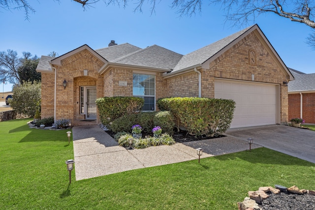 view of front facade featuring a garage, a shingled roof, a front lawn, and brick siding