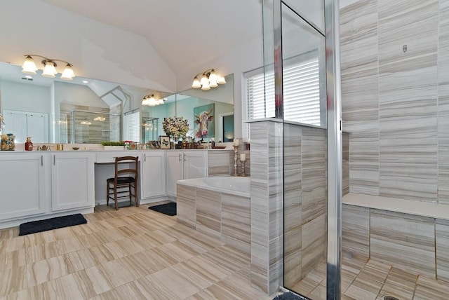 bathroom featuring vaulted ceiling, a stall shower, vanity, and a bath