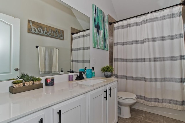 full bathroom featuring vanity, shower / bath combo with shower curtain, tile patterned flooring, and toilet