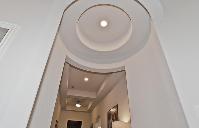 interior details featuring a raised ceiling and recessed lighting