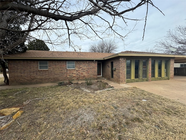 view of front facade with a patio area and brick siding