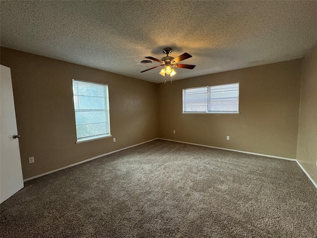 spare room with ceiling fan, a textured ceiling, carpet flooring, and baseboards