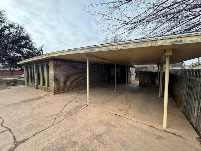 view of parking featuring a carport and fence