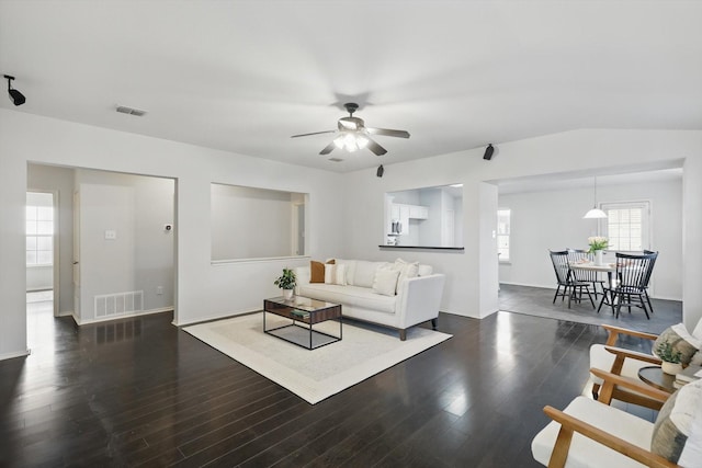2725 Calmwater Dr, Little Elm, TX 75068 - living area featuring baseboards, ceiling fan, dark wood-style floors, and visible vents
