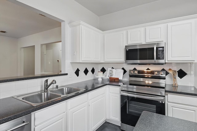 2725 Calmwater Dr, Little Elm, TX 75068 - kitchen featuring visible vents, a kitchen island, dark countertops, white cabinetry, and appliances with stainless steel finishes