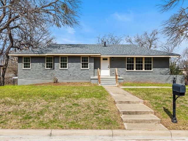 ranch-style house with a front yard, brick siding, and roof with shingles