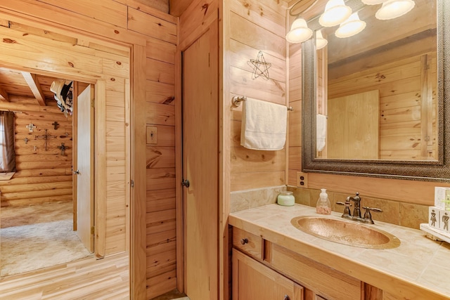 bathroom featuring log walls and vanity