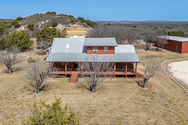 exterior space featuring metal roof, a mountain view, and a porch