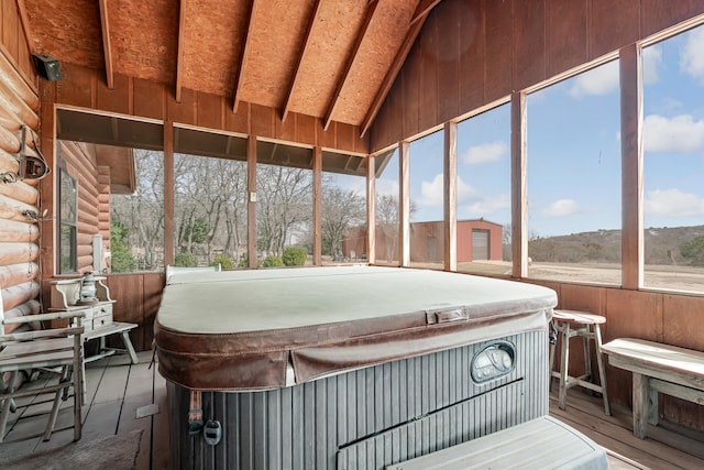 sunroom / solarium featuring lofted ceiling and a jacuzzi