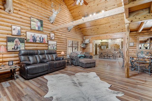 living area featuring high vaulted ceiling, wooden ceiling, wood finished floors, and rustic walls