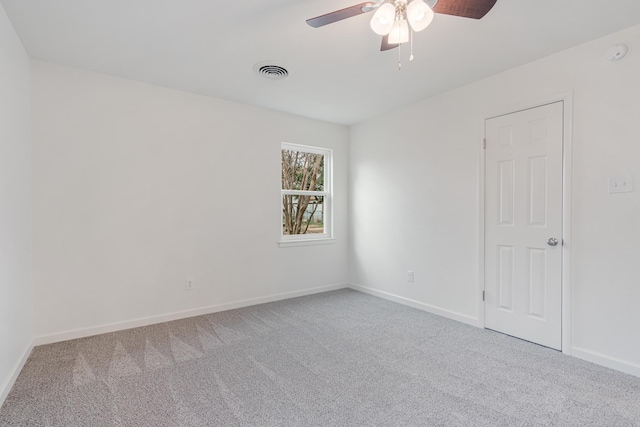 spare room with baseboards, visible vents, and carpet flooring