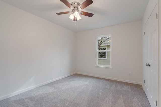 empty room featuring light carpet, ceiling fan, and baseboards