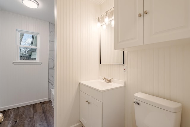 full bathroom featuring baseboards, vanity, toilet, and wood finished floors