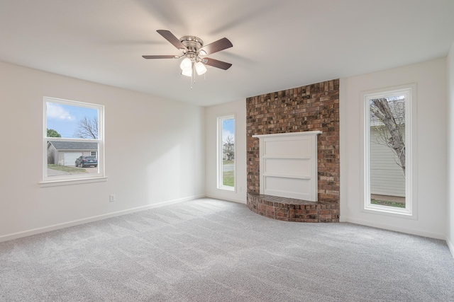 unfurnished living room with a ceiling fan, carpet, and baseboards