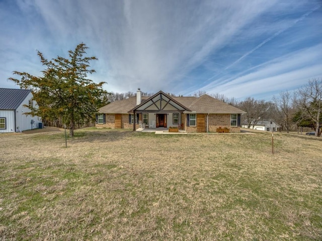 view of front of house with a front lawn and a chimney