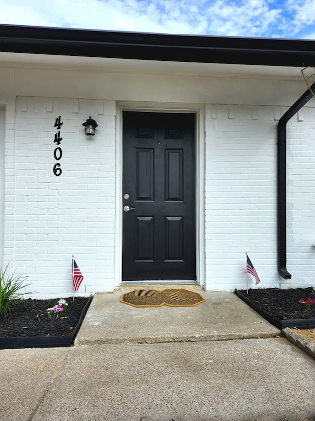 property entrance with brick siding