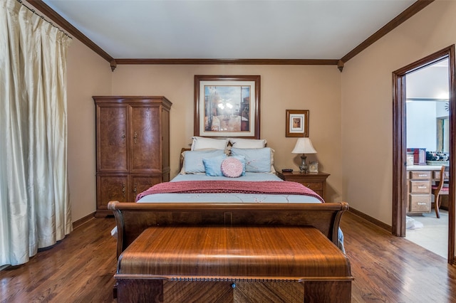 bedroom with baseboards, wood finished floors, and crown molding