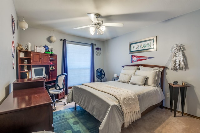 carpeted bedroom featuring a ceiling fan and baseboards