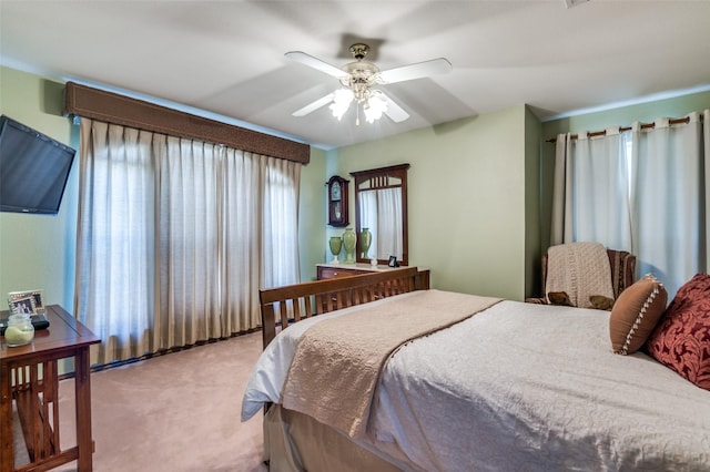 bedroom featuring a ceiling fan and light colored carpet