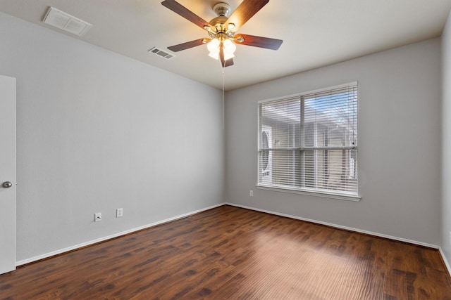 unfurnished room featuring ceiling fan, wood finished floors, visible vents, and baseboards