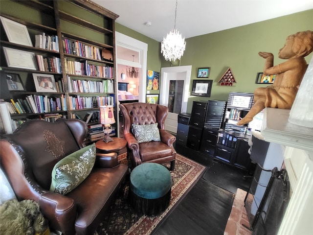 sitting room featuring a notable chandelier and wood finished floors