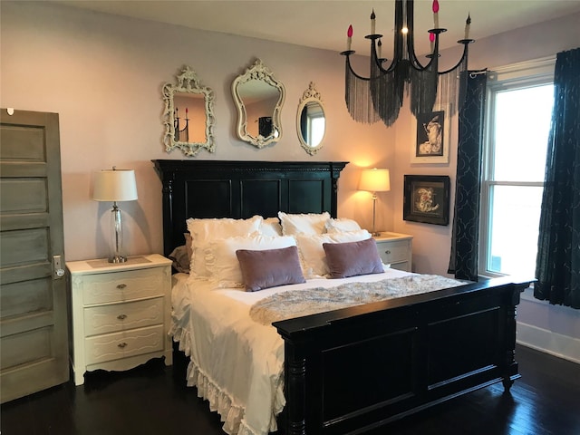 bedroom featuring multiple windows, dark wood finished floors, and baseboards