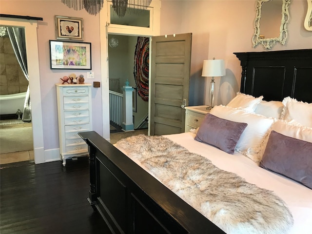 bedroom featuring a closet, baseboards, and dark wood-style flooring