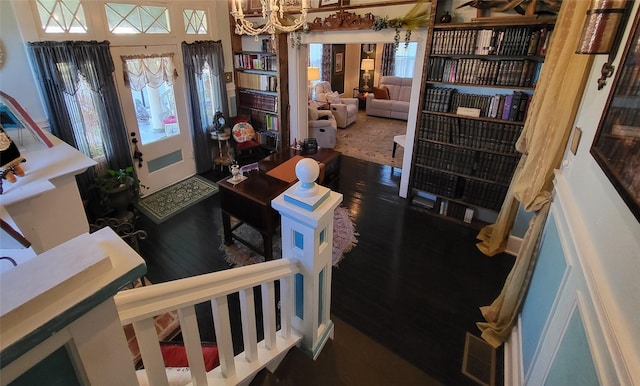 entrance foyer with a notable chandelier and wood finished floors