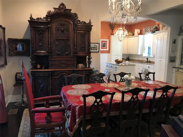 dining space featuring a chandelier and arched walkways