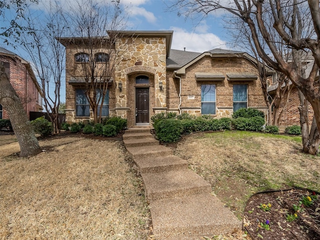 view of front of property with stone siding, brick siding, and roof with shingles